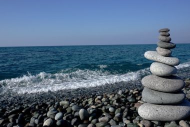 a stack of rocks sitting on top of a rocky beach